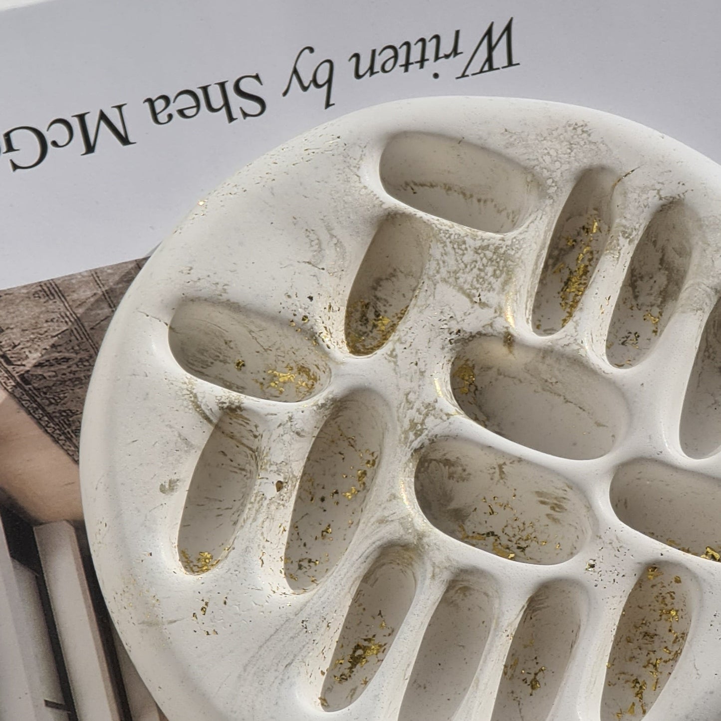 White gold highlight ring holder on magazine with text on a white background