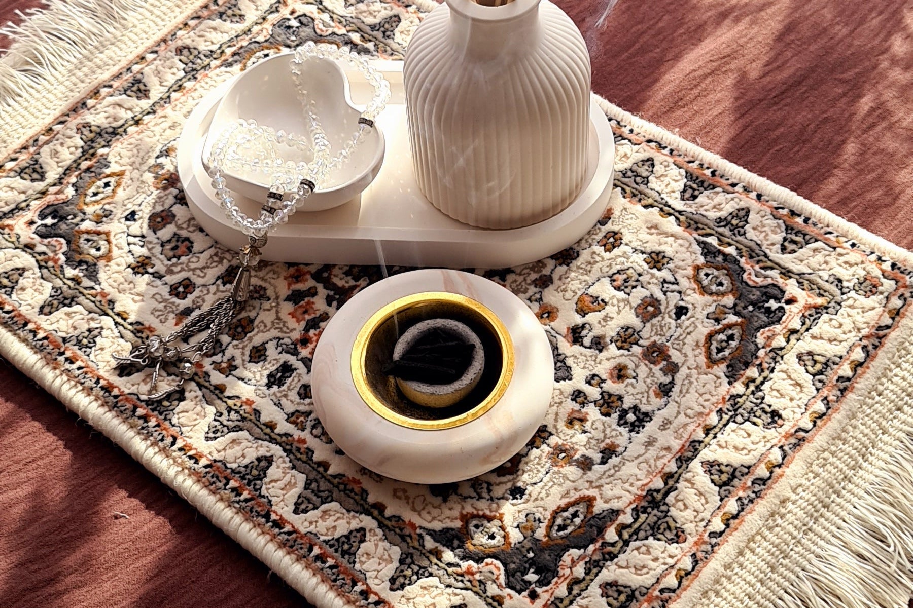 Layali bukhoor burner with gentle incense smoke in soft morning light