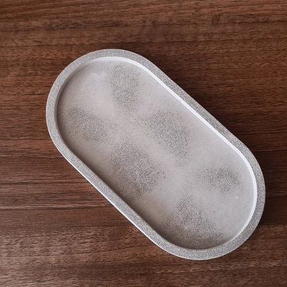 Gray oval stone on a wooden surface.