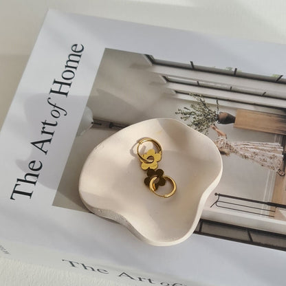 Petal dish in natural lighting, on a book called 'The Art of Home'