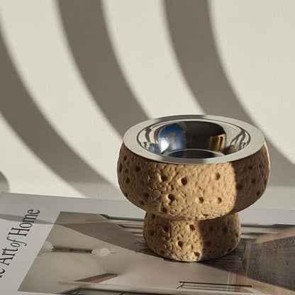 Manzil bukhoor burner on a book 'art of the home, with white shadowed background