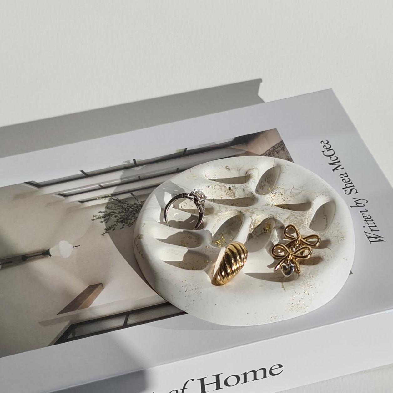 Book titled 'The Art of Home' with a ring holder on a white background.