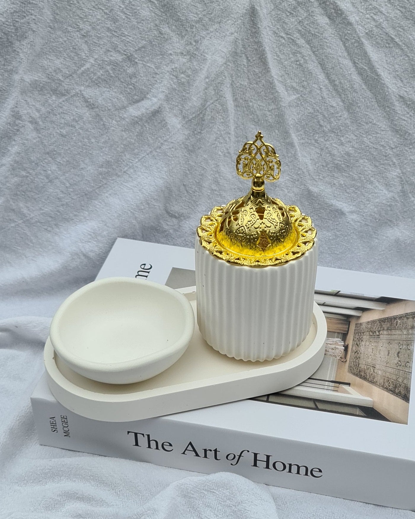 Raayah incense burner set by MINKO HOME — gold dome burner, small round dish, and oval tray in soft natural tones against a light linen backdrop.