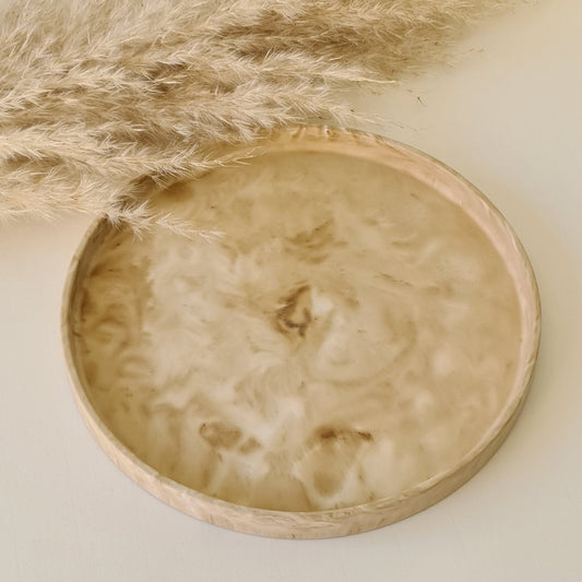 Large decorative tray on a white surface with pampas